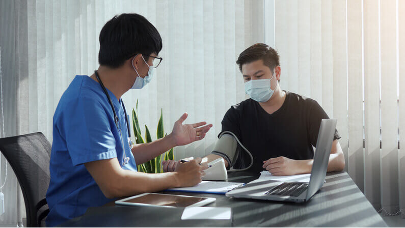 doctor doing physical exam on a male patient