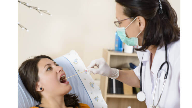 female doctor doing throat culture procedure on a patient