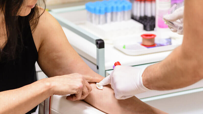 medical personnel taking blood test in a patient