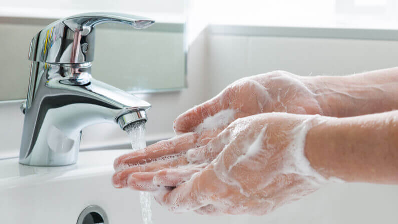 person properly washing hands