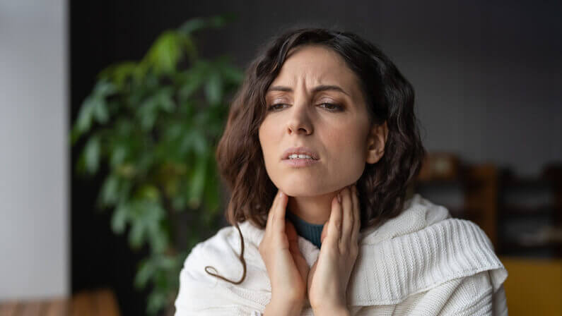 women suffering from pharyngitis