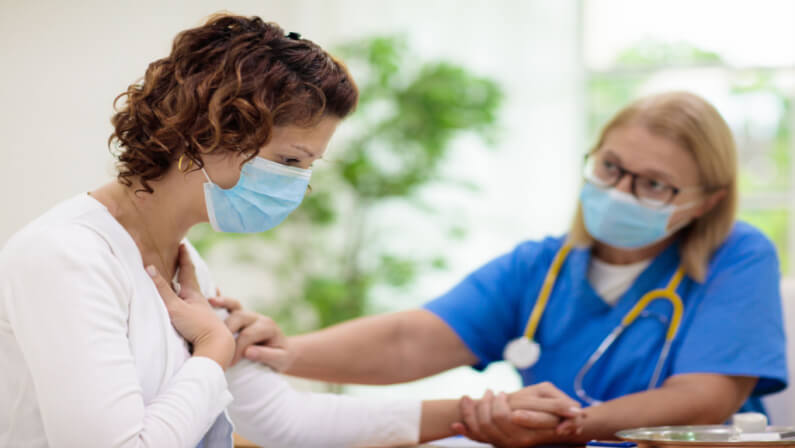 female patient consulting with her doctor about chest pain