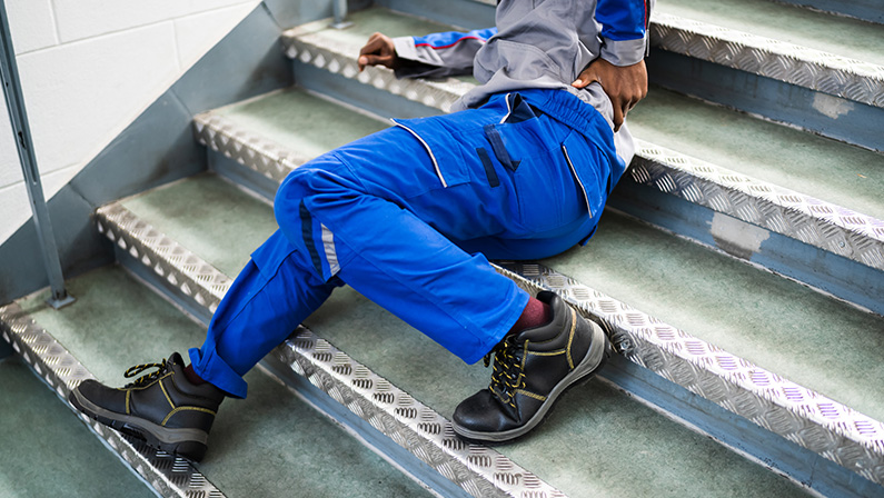 Worker Man Lying On Staircase After Slip And Fall Accident