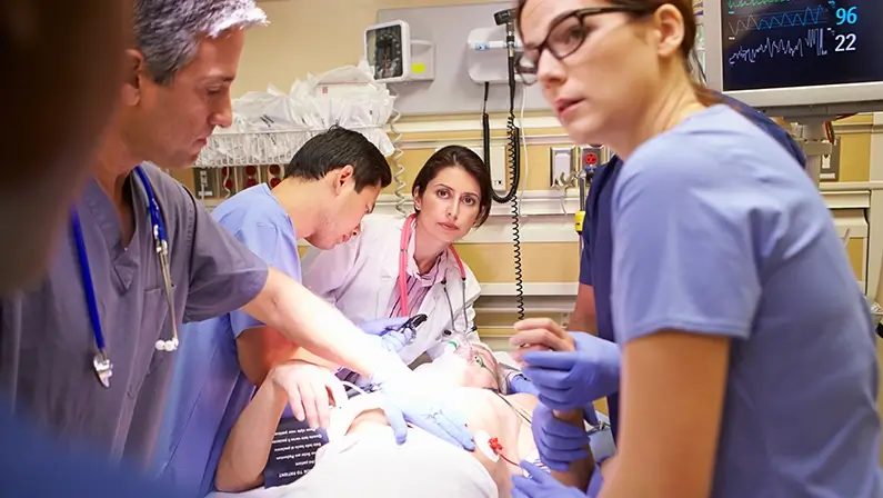 Medical Team Working On Patient In Emergency Room