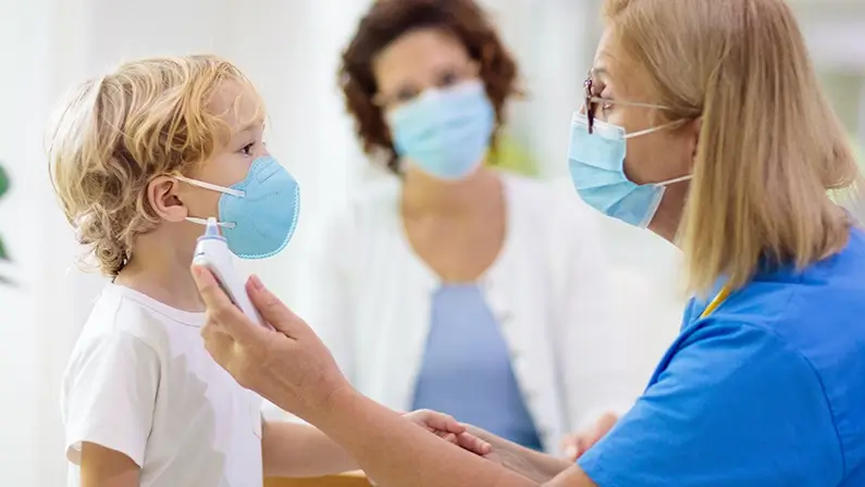 Pediatrician doctor examining sick child in face mask. Ill boy in health clinic for test and screening. Kids home treatment of virus. Coronavirus pandemic. Covid-19 outbreak. Patient coughing.