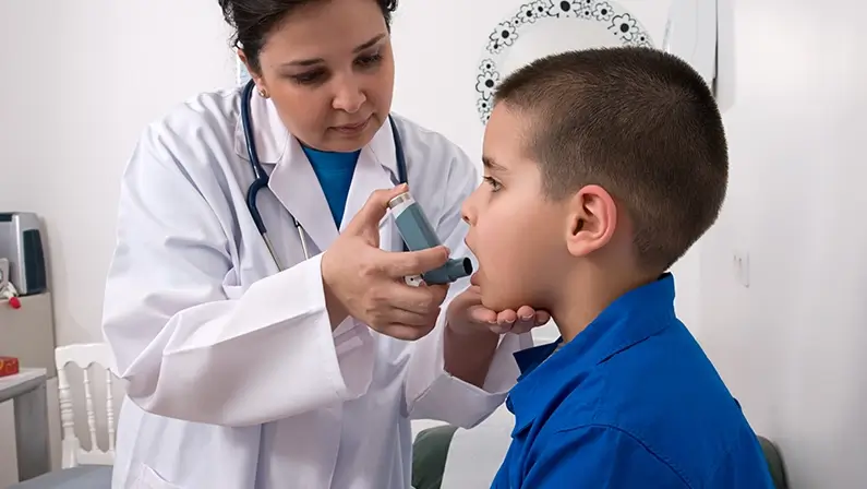 Medical doctor applying oxygen treatment on a little boy with asthma