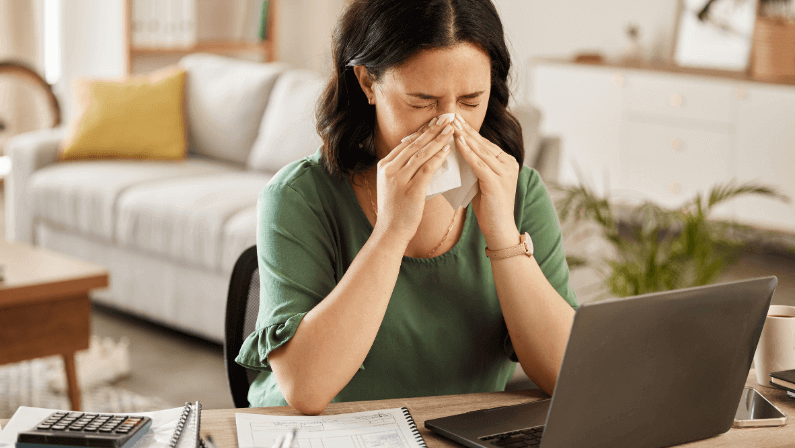 sick woman in home office with flu, cold or viral infection 