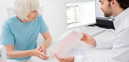 cardiologist consults an elderly woman on the results of a cardiogram and tests. Arrhythmia and heart disease, diagnosis