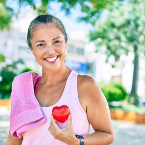 A Post exercise photo of a lady with an apple