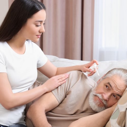 woman taking care of his father's fungal ear infection using home remedies